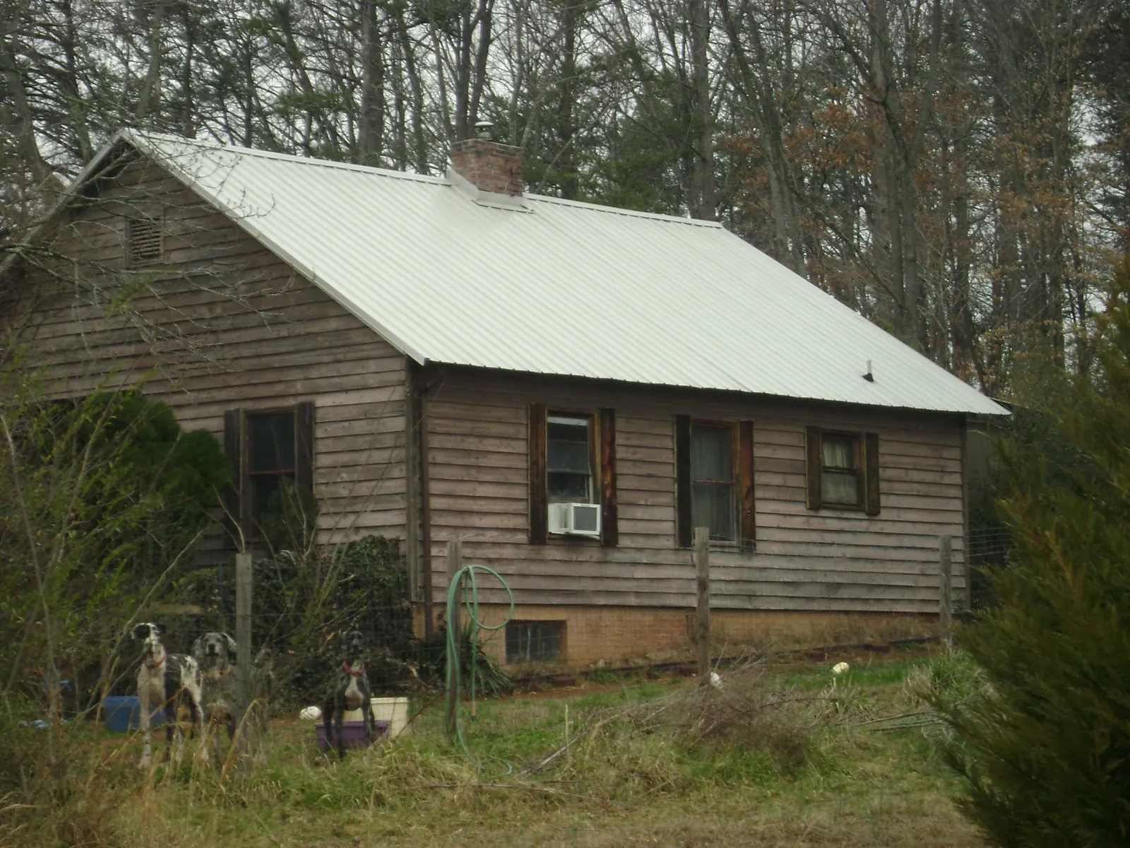 White metal roof on an old wood sided farmhouse, from a Metal Roof Installation job in North Springfield